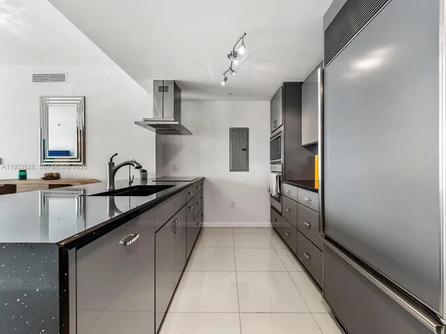 a large kitchen with cabinets and stainless steel appliances