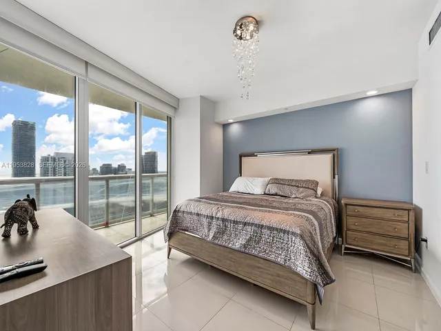 a bedroom with a bed and a night stand