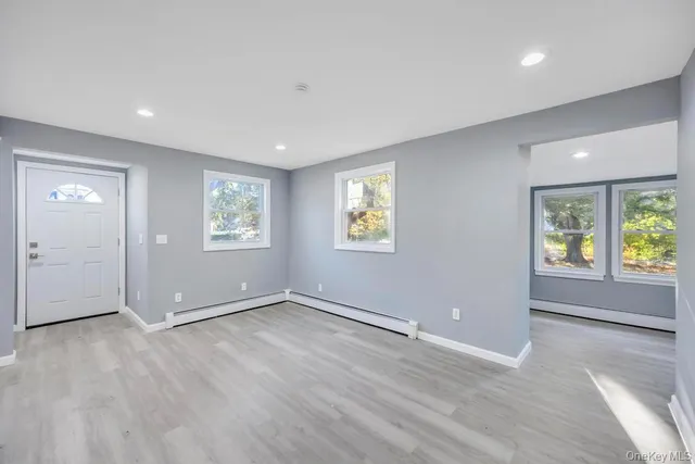 an empty room with windows and closet