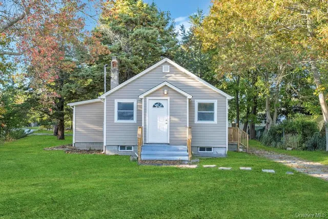 a front view of house with a garden
