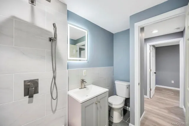 a bathroom with a sink toilet and vanity