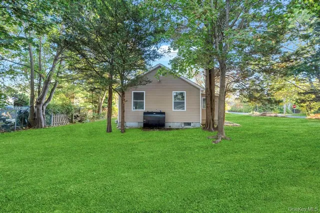 a house with green field in front of it