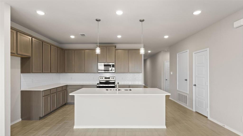 361 Deer Rdg Drive Aledo, TX 76008 - Photo 7 of 25 a view of kitchen with stainless steel appliances kitchen island a sink a stove and a refrigerator