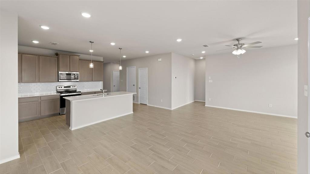 361 Deer Rdg Drive Aledo, TX 76008 - Photo 11 of 25 a view of kitchen with kitchen island stainless steel appliances cabinets a sink and a counter top space
