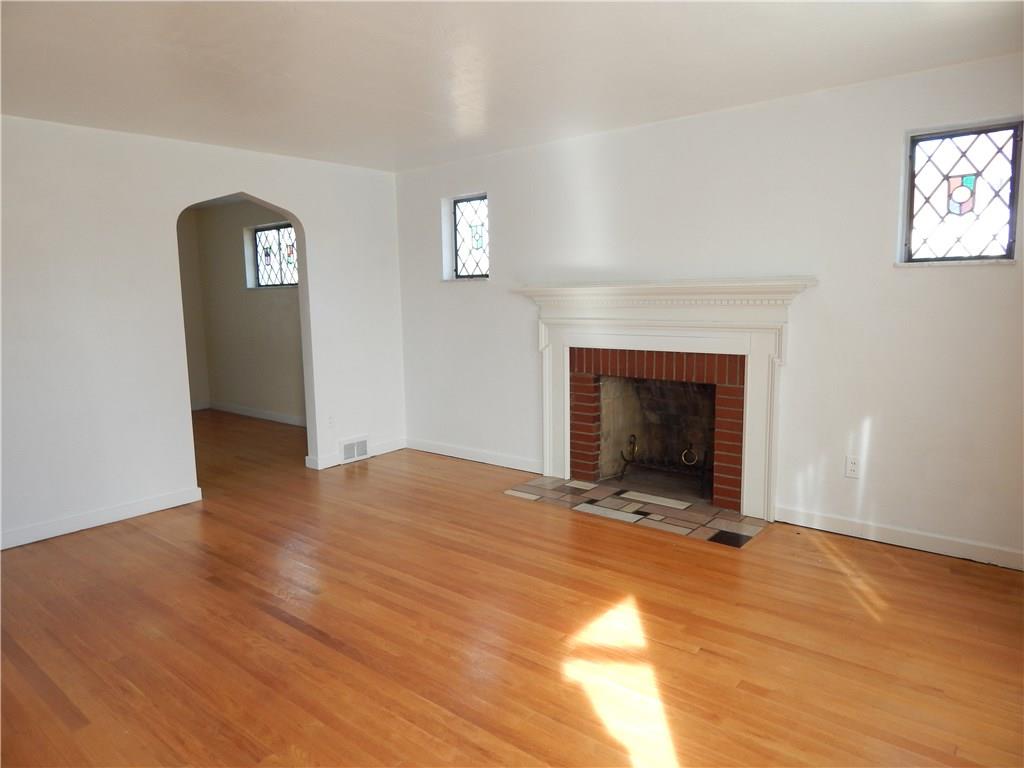 2009 Mohawk Road Upper St. Clair, PA 15241 - Photo 2 of 15 LIVING ROOM - Hardwood floors, gas fireplace with wood mantle, arched doorway