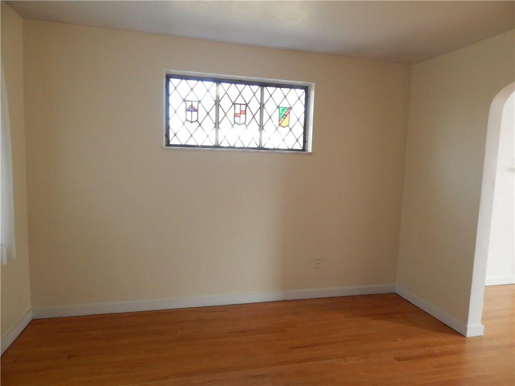 2009 Mohawk Road Upper St. Clair, PA 15241 - Photo 3 of 15 DINING ROOM - Hardwood floors, stained glass window, arched doorway
