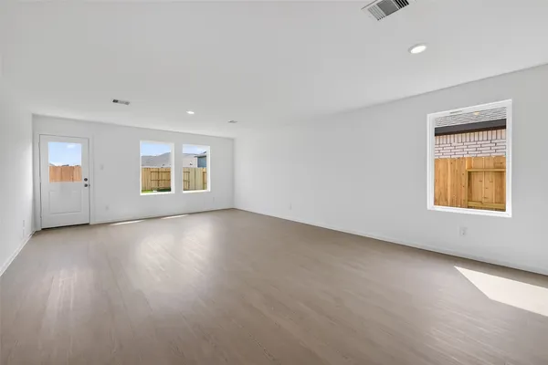 an empty room with windows and closet