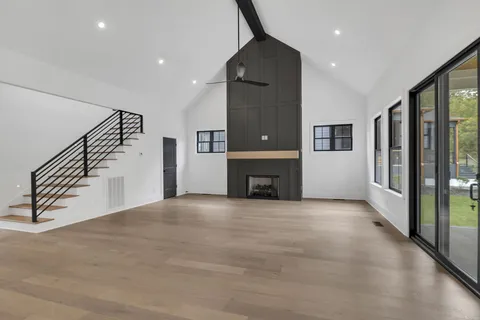 a view of an empty room with a fireplace and a window
