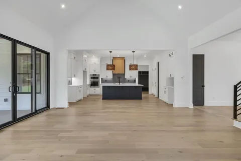 a view of a kitchen with a sink and a refrigerator