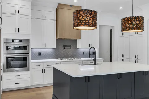 a kitchen with stainless steel appliances a sink stove and cabinets