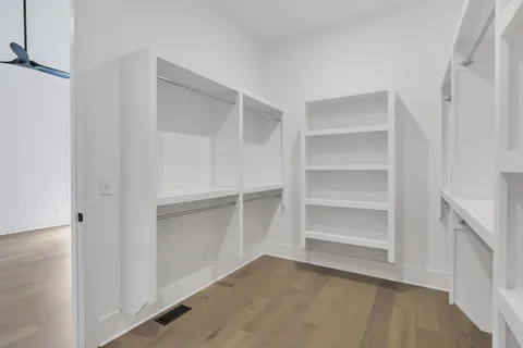 a view of an empty walk in closet with empty racks