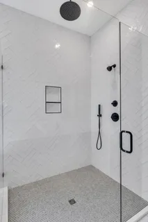 a bathroom with a shower and a window