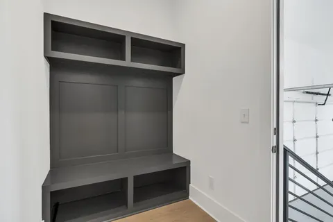 an empty room with windows and ceiling fan