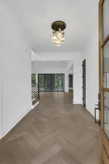 a view of an empty room with a fireplace and a large window