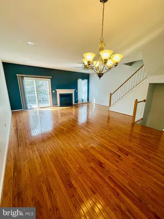 wooden floor in an empty room with stairs