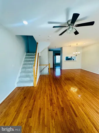 an empty room with fan and entrance