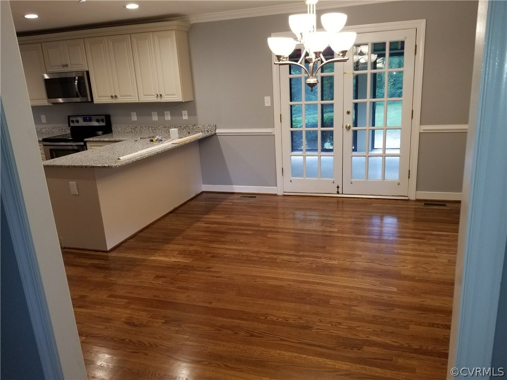 4117 Cresthill Road Chester, VA 23831 - Photo 18 of 40 a kitchen with stainless steel appliances granite countertop a sink stove and cabinets