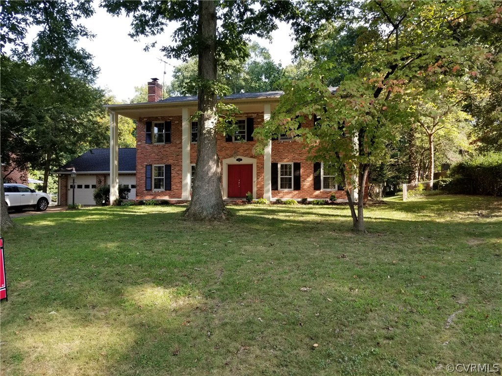 4117 Cresthill Road Chester, VA 23831 - Photo 3 of 40 a front view of a building with a garden
