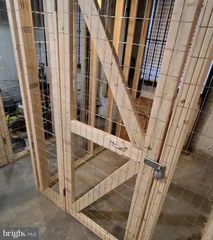 a view of staircase with railing and white walls