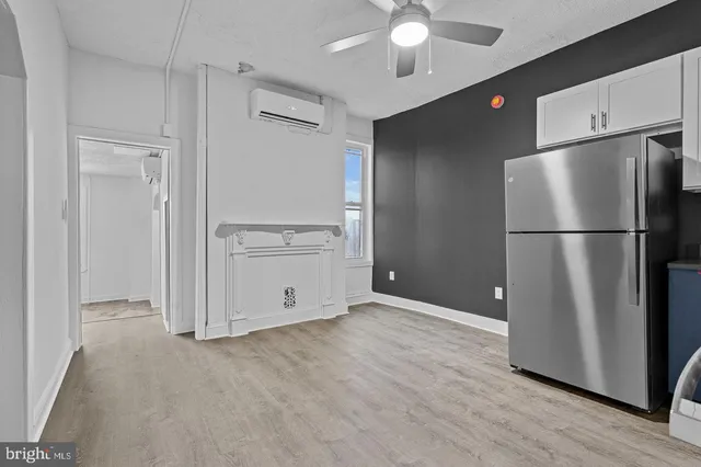 a view of a kitchen with a refrigerator and a stove top oven
