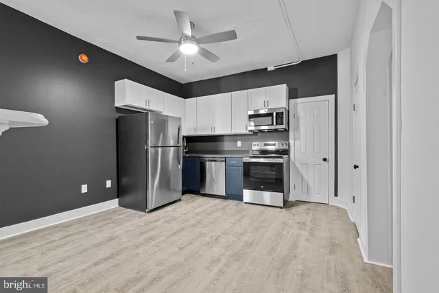 a kitchen with stainless steel appliances a refrigerator and a stove top oven