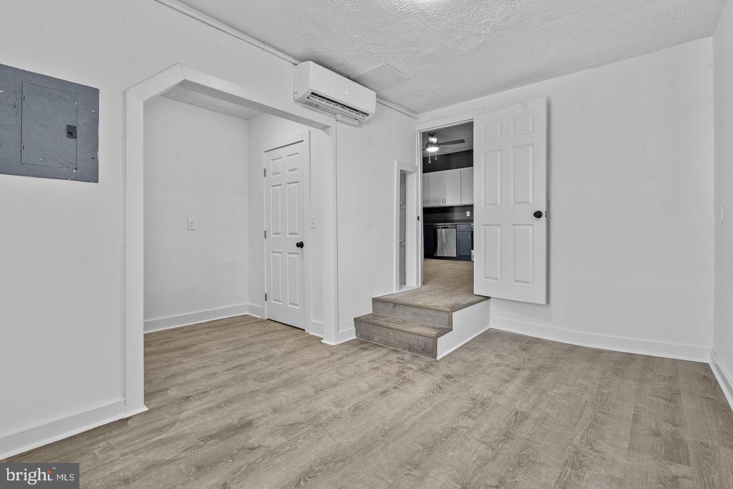 1308 West Lexington Street, Unit 3R Baltimore, MD 21223 - Photo 6 of 16 a view of empty room with wooden floor and cabinet