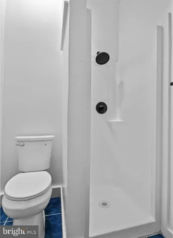 a bathroom with a toilet and a shower