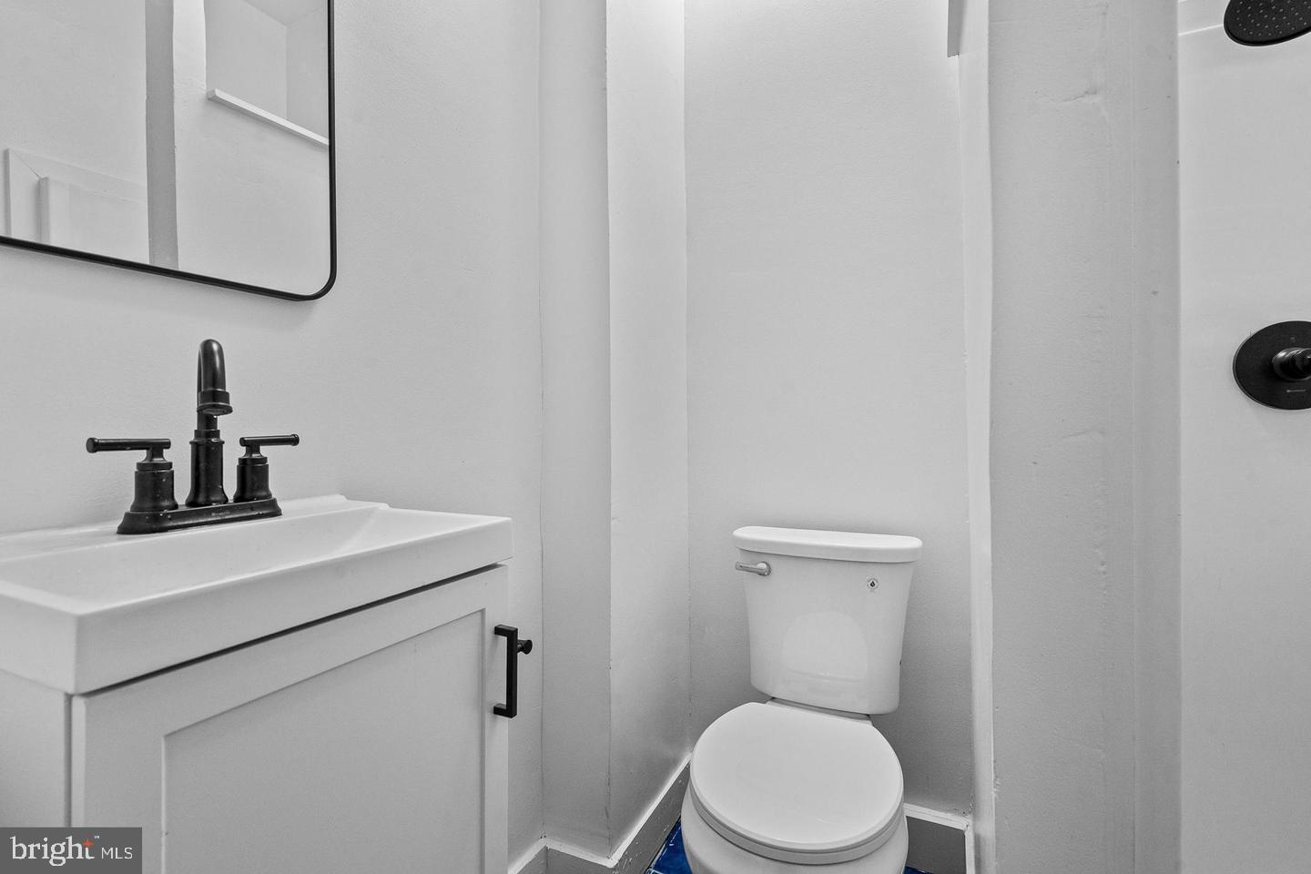 1308 West Lexington Street, Unit 3R Baltimore, MD 21223 - Photo 10 of 16 a bathroom with a toilet a sink and mirror