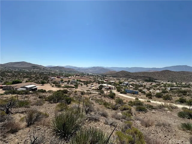 an aerial view of residential houses with city view