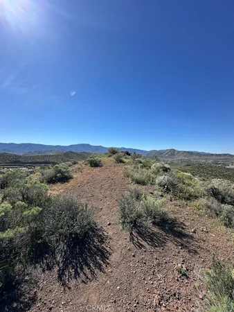 a view of a large mountain with mountains in the background