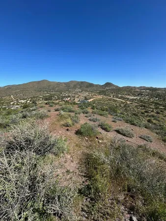 a view of a mountain range in a cloudy sky