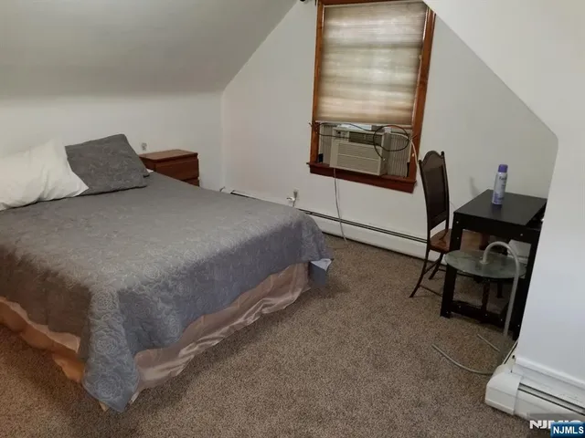 a bedroom with a bed a desk and chair