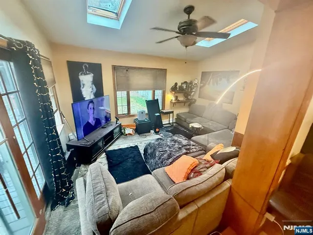 a living room with furniture a fireplace and a chandelier