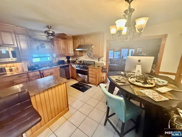a view of a dining room with furniture a chandelier and wooden floor