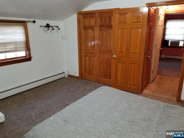 a bedroom with a bed a desk and chair