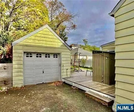 a view of a house with a wooden fence