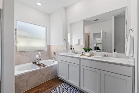 a bathroom with a double vanity sink mirror and