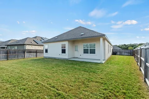 a view of a backyard of the house