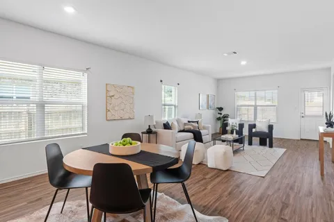 a living room with furniture and wooden floor
