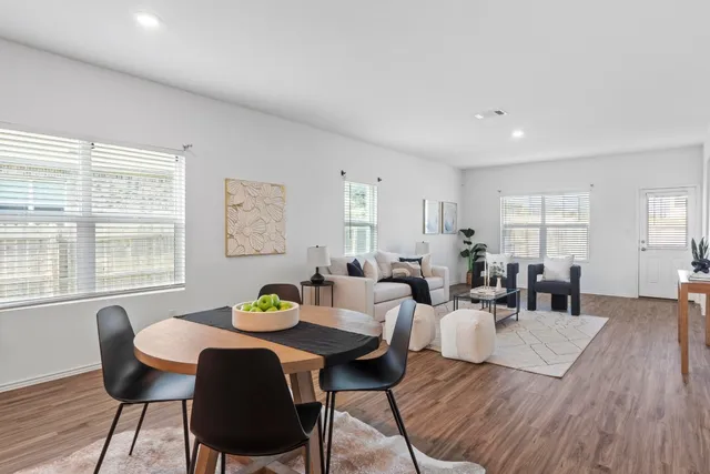 a living room with furniture and wooden floor