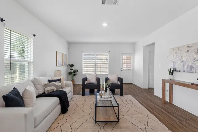 a living room with furniture a dining table and a piano table