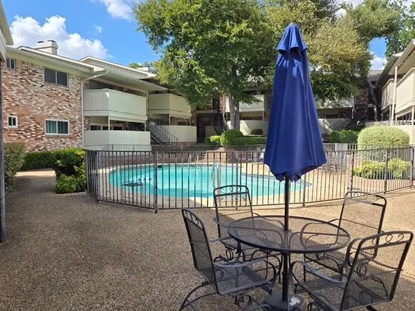 a view of a chairs and table in patio