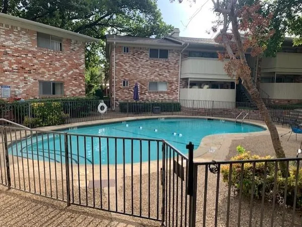 a view of house with backyard and furniture
