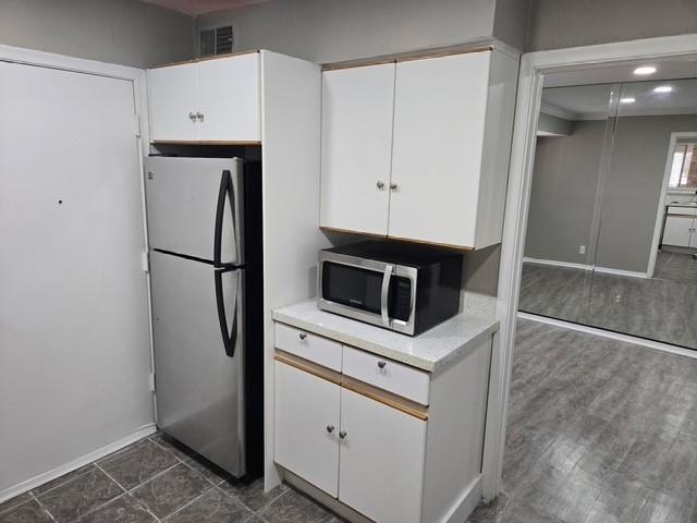 7812 Royal Lane, Unit 210 Dallas, TX 75230 - Photo 5 of 23 a kitchen with white cabinets and white appliances