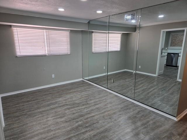 7812 Royal Lane, Unit 210 Dallas, TX 75230 - Photo 6 of 23 an empty room with wooden floor and a window