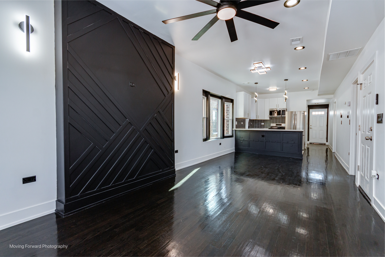 4941 West Iowa Street Chicago, IL 60651 - Photo 23 of 44 a view of a refrigerator in kitchen and an empty room with wooden floor