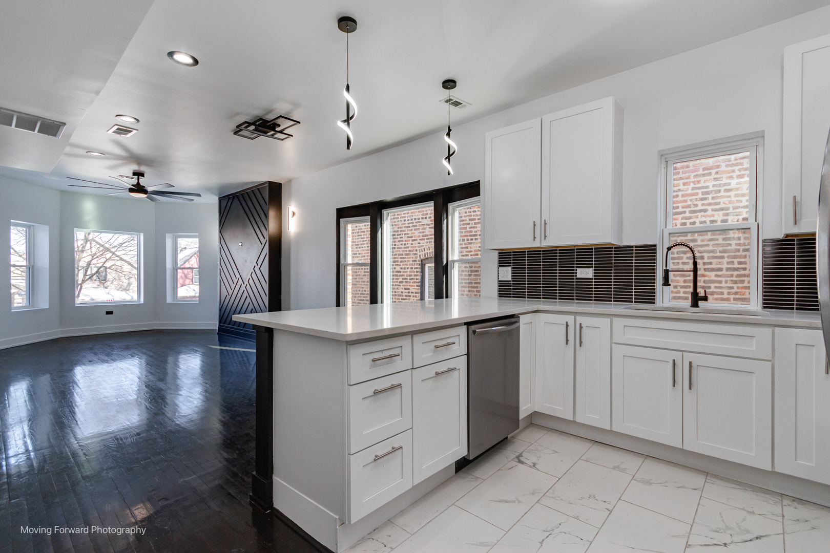 4941 West Iowa Street Chicago, IL 60651 - Photo 24 of 44 a kitchen with granite countertop white cabinets white appliances a sink and a window