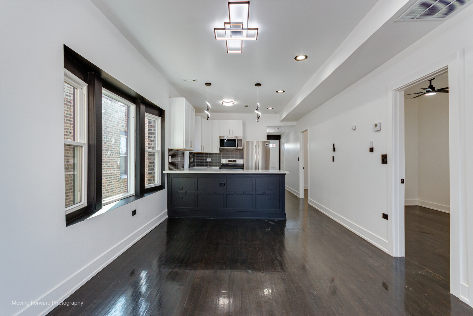 4941 West Iowa Street Chicago, IL 60651 - Photo 27 of 44 a large kitchen with stainless steel appliances a large counter top a refrigerator and a sink