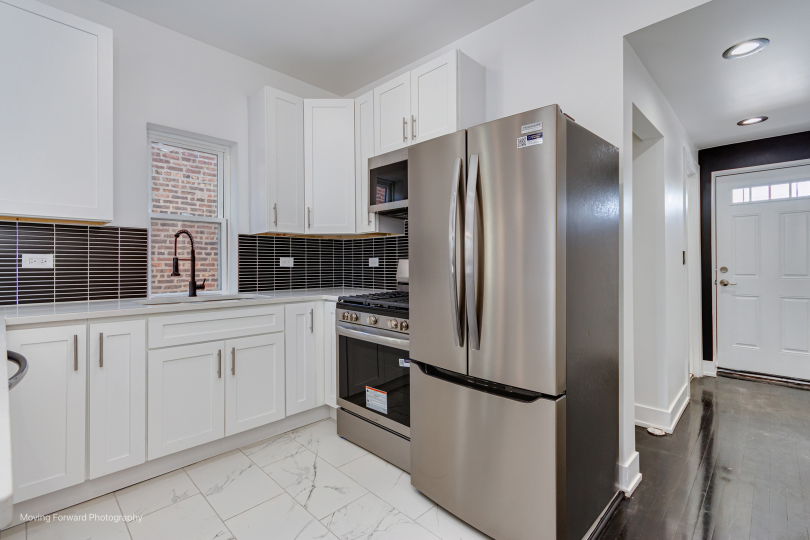 4941 West Iowa Street Chicago, IL 60651 - Photo 30 of 44 a kitchen with stainless steel appliances a refrigerator sink and cabinets
