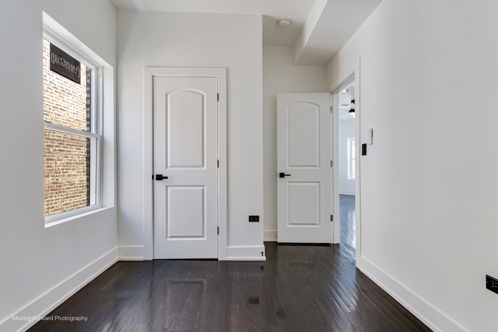 4941 West Iowa Street Chicago, IL 60651 - Photo 35 of 44 an empty room with wooden floor and windows